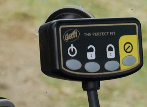 Close-up of the Geith Control Box labeled 'The Perfect Fit', featuring buttons with lock icons and a bypass button, signifying its safety measures and ease of operation.
