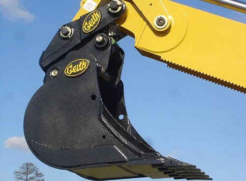 Geith bucket attached to yellow excavator arm, showing brand logo and robust design.