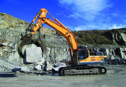 Geith Mechanical grapple on an orange excavator at a rocky quarry, suitable for 18 to 41t excavators.